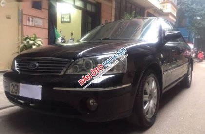 Ford Laser   Ghia 1.8 2004 - Cần bán lại xe Ford Laser Ghia 1.8 sản xuất 2004, màu đen số tự động