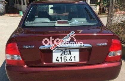 Mazda 323 2004 - Cần bán xe Mazda 323 năm sản xuất 2004, màu đỏ, xe nhập